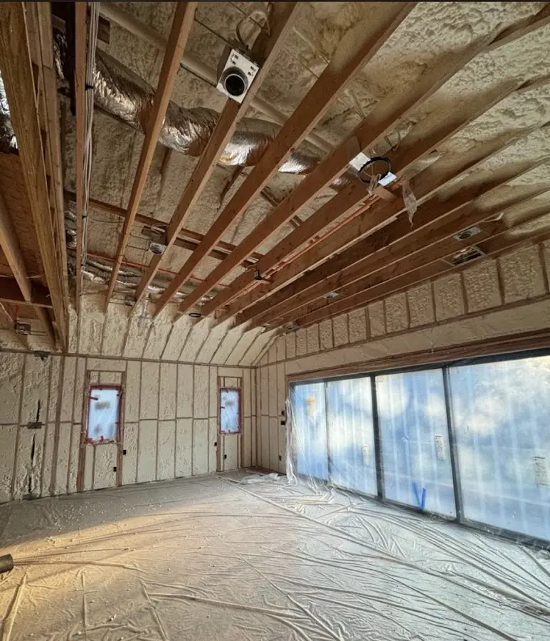 Interior walls and ceiling insulated with spray foam during new construction in Half Moon Bay